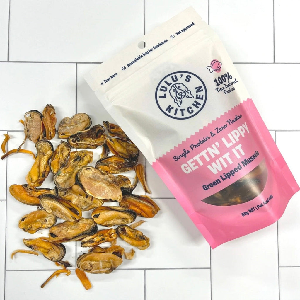 Dried green lipped mussels next to a Lulu's Kitchen packaging on a white tiled background